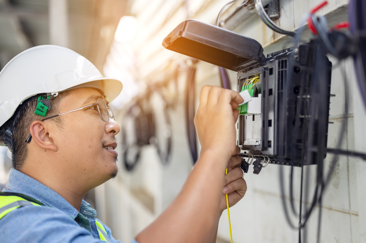 A broadband technician connecting fiber infrastructure
