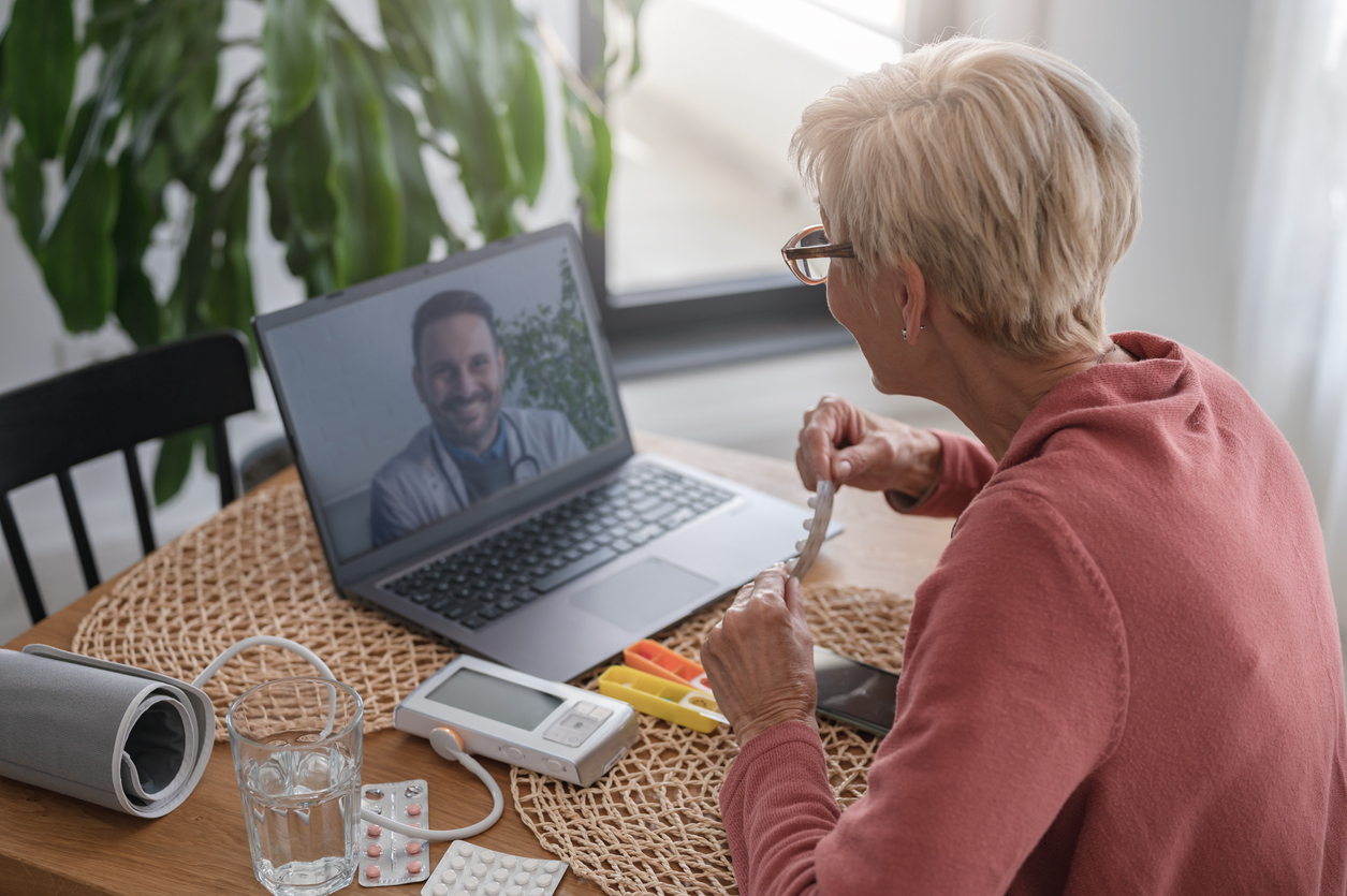 An older adult managing medications during a virtual care visit